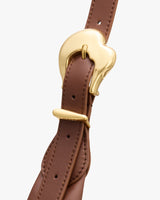 Close-up of a belt with a shiny buckle