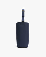 Side view of a minimalistic bag with a single strap and buckle.