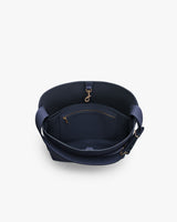 Open-top bag with interior zip pocket and wide strap.