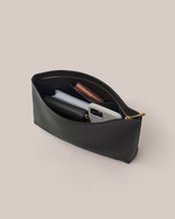 Open pouch containing phone, wallet, and small items.