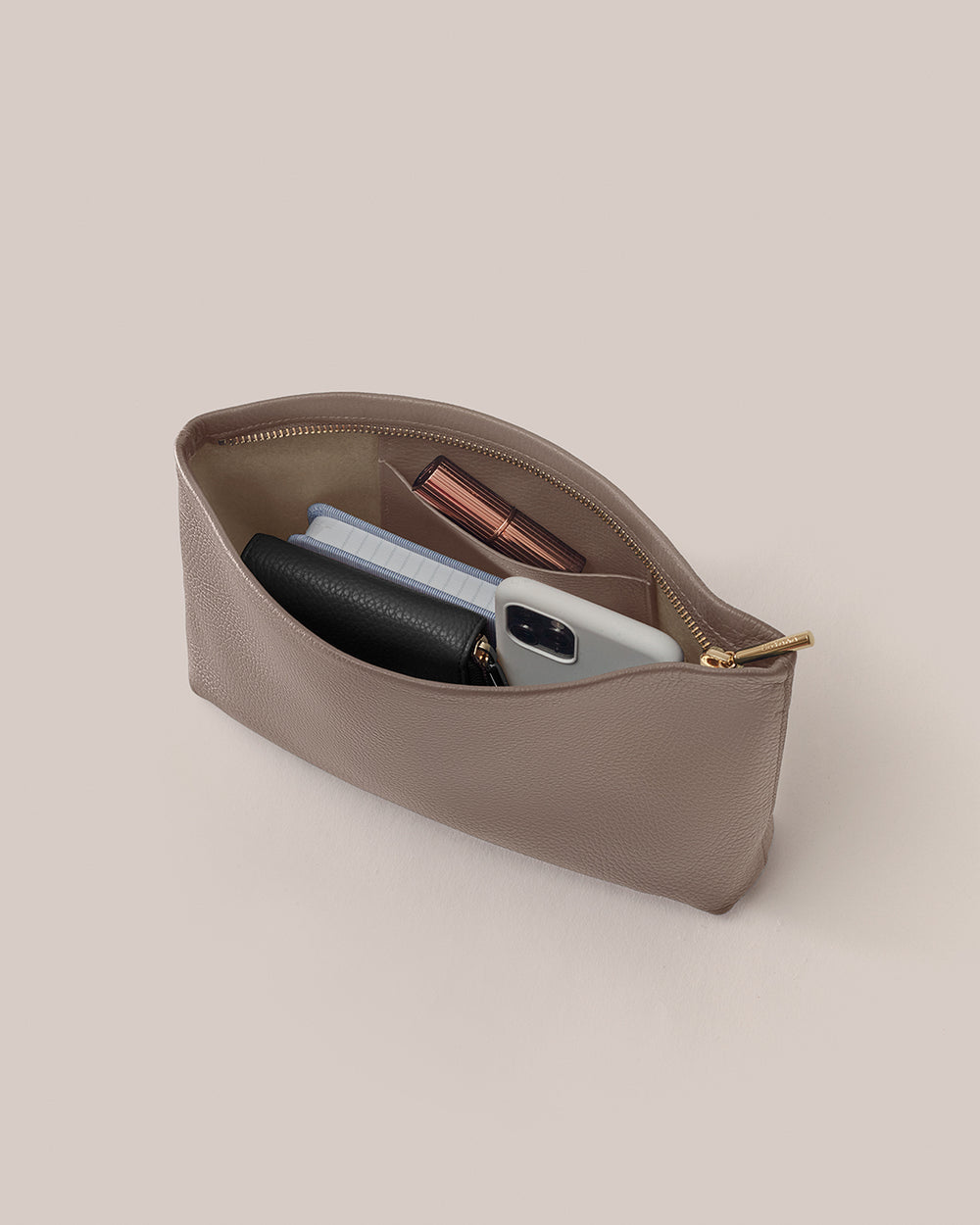 Small Zipper Pouch Pouch containing wallet, phone, and a few other small items.