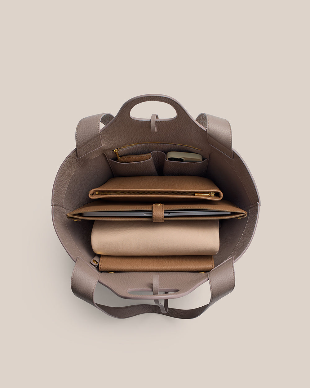 Paloma Tote Open tote bag with organized compartments, holding various items like wallets and accessories.