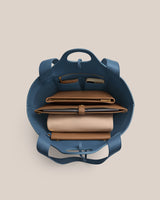 Open handbag showing neatly organized contents inside.