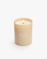 Lit candle in a simple container with text on it.