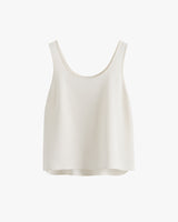 Sleeveless top with a rounded neckline hanging on plain background.
