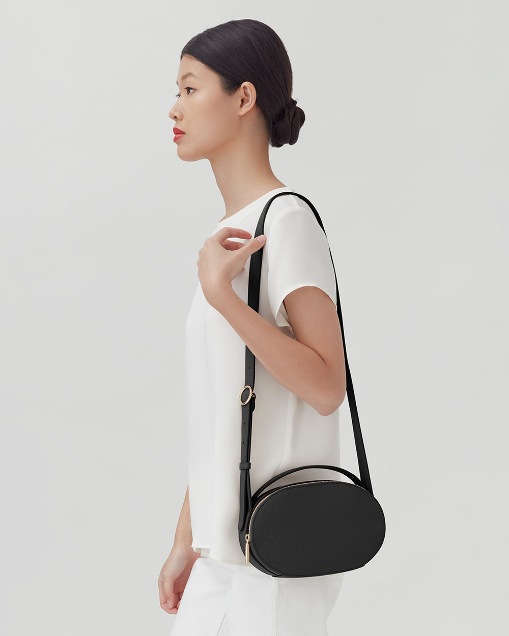 Woman side profile carrying shoulder bag