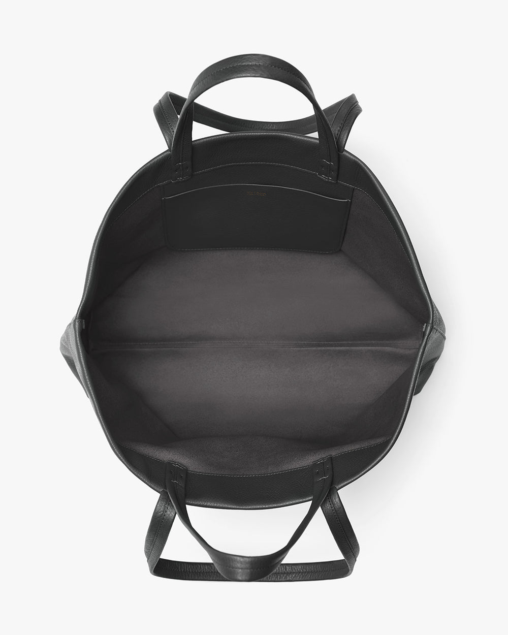 Open backpack viewed from the top with visible handles and straps.