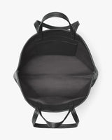 Open backpack viewed from the top with visible handles and straps.