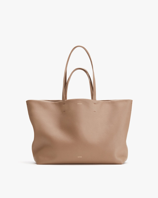 Large tote bag with two handles standing upright.
