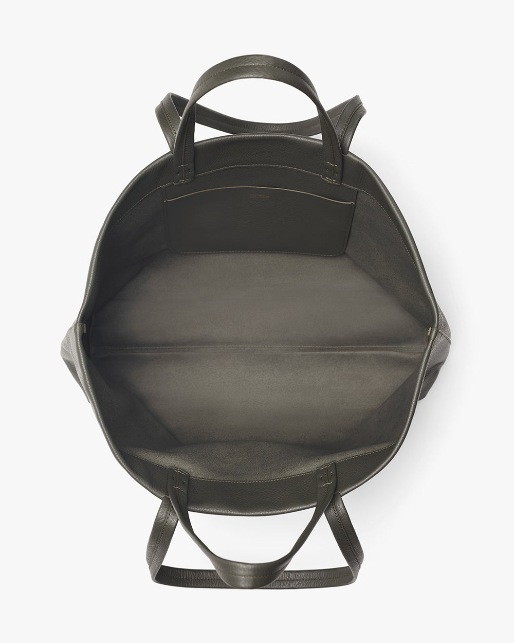 Top view of an open, empty backpack with visible handles and top flap.