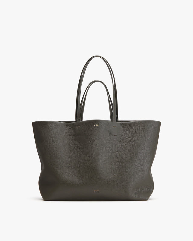 Large tote bag with two handles and a small brand logo.