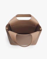 Open handbag with a handle and spacious interior pocket.