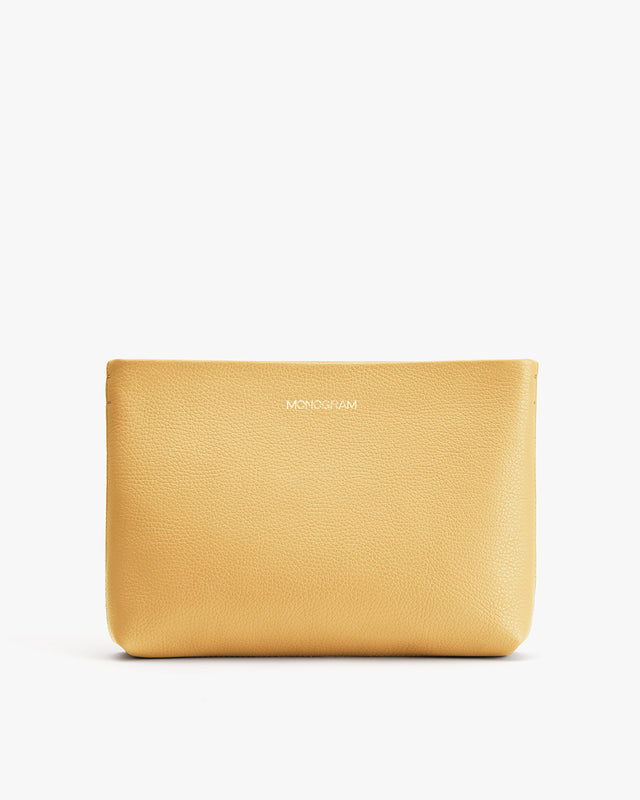 Leather pouch with brand name embossed on front.