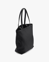 Tote bag standing upright with dual handles.