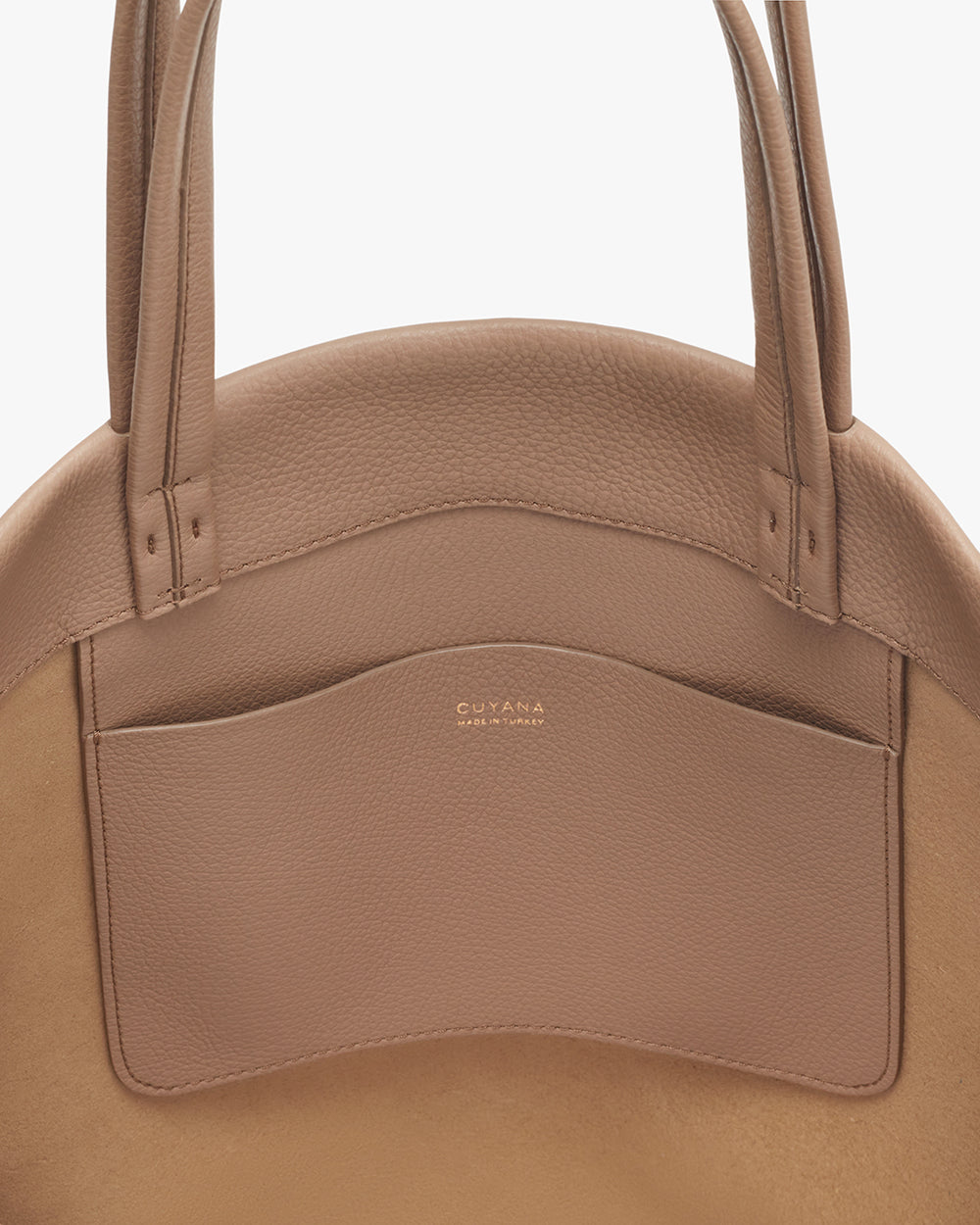 Tall Easy Tote Close-up of a handbag with a brand logo on the front pocket.