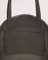 Handbag with two straps and a front pocket, branded logo visible.