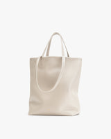 Vertical tote bag with two handles standing upright.