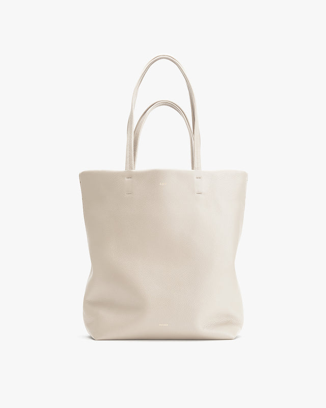 Upright tote bag with two handles, standing against a plain background.