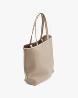 Tall tote bag standing upright with two handles.