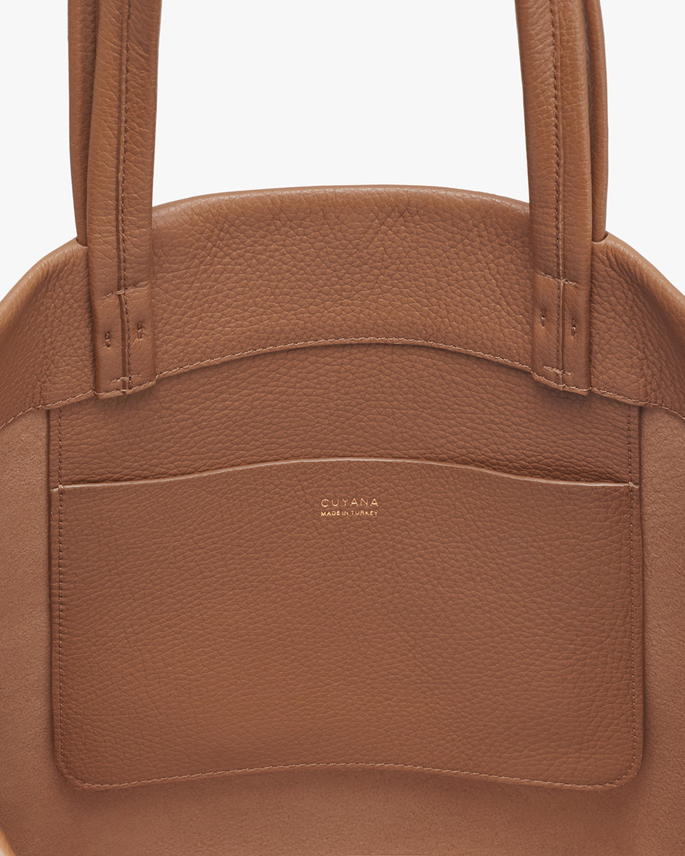 Close-up view of a handbag with a brand logo on the front pocket.