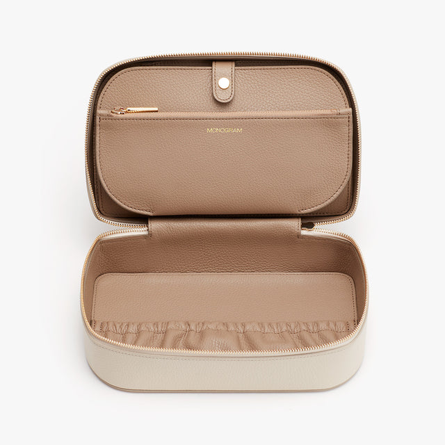 Open jewelry case with compartments and a zipper.