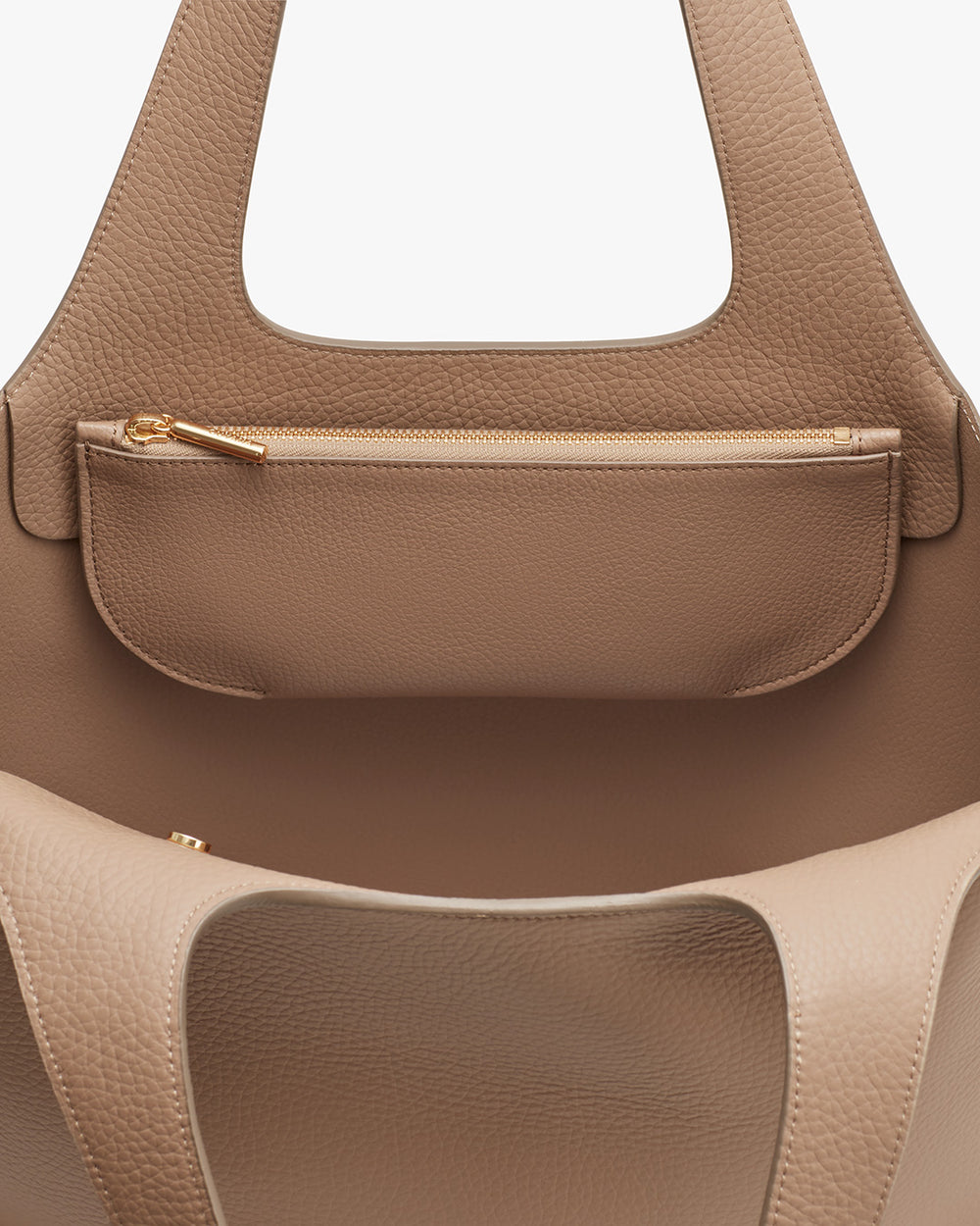 Close-up of a handbag with a zipper pocket.