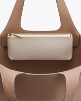 Handbag with a zipper pouch hanging on the front.