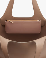 Purse with zipper pouch suspended between two handles