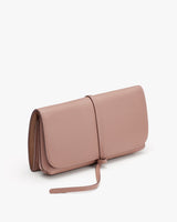 Small handbag with a strap on a plain background.