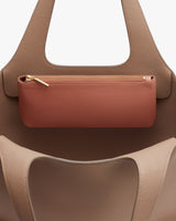 Handbag with a small purse attached inside.