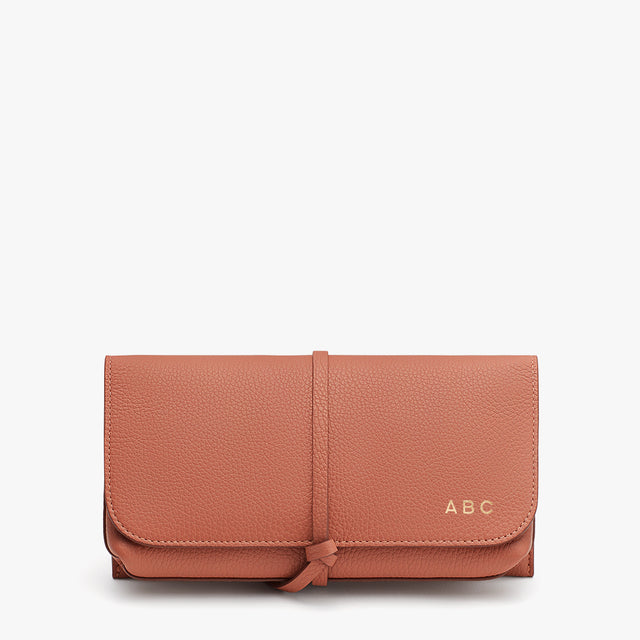 Wallet with a strap and initials ABC on the front.