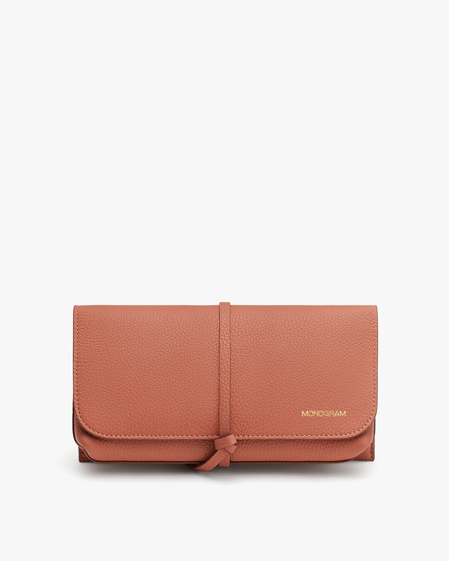 Wallet on a plain background with a logo and wrap-around fastening.