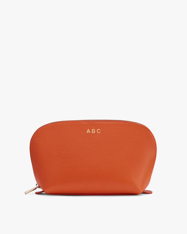 Textured pouch with zipper and initials ABC on the front.