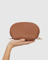 Hand holding a small zippered pouch