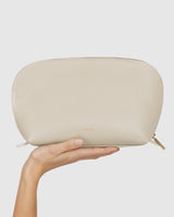 Hand holding a small zipped pouch