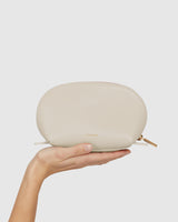 Hand holding a small zippered pouch