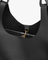 Close-up view of a handbag with a metal clasp detail.