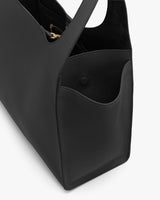 Open handbag with visible interior and a side pocket.