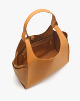 Open handbag viewed from above showing interior and pockets.