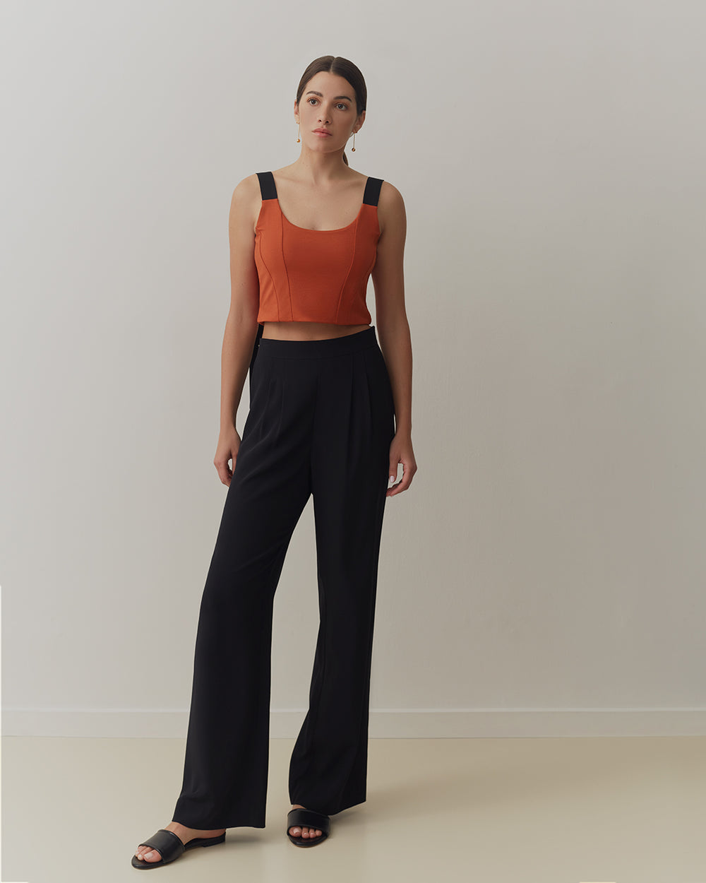 Duo Midi Dress Model wearing a sleeveless top with wide-leg trousers and open-toe sandals