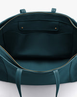 Open travel bag showing spacious interior with zippered closure and two interior pockets with flaps