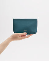 A hand holding a small pouch