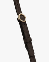 Close-up of a leather strap with a metal ring.