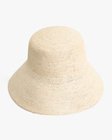 A woven bucket hat placed on a plain surface.