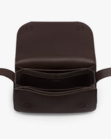 Open leather bag with two visible compartments and flap.