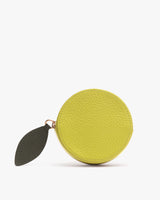Round coin purse with leaf-shaped zipper pull.