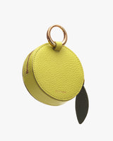 Round, textured leather coin purse with a zipper and metal ring.