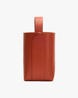 Leather bucket bag with a single handle on top.