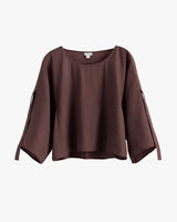 Loose-fitting, three quarter sleeve blouse with wide neckline.