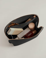 Open pouch with cosmetics and brushes inside